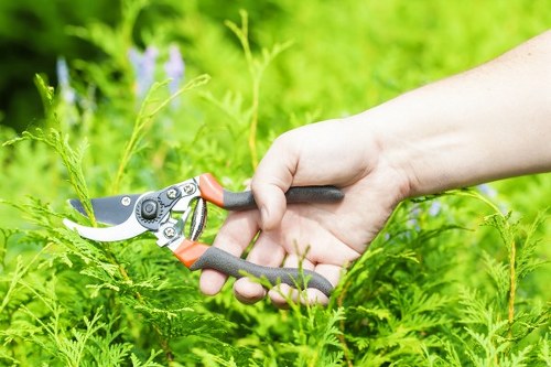 Electric gardening van parked with tools and wheelbarrow